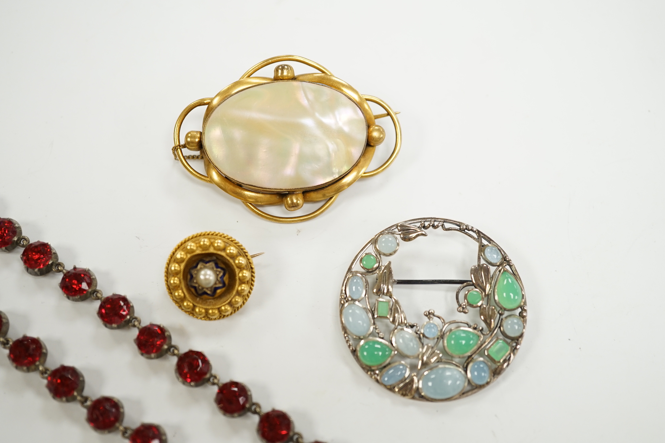 A late Victorian yellow metal, enamel and split pearl set circular brooch, 18mm, a modern 925 and gem set Sibyl Dunlop style brooch and two other items.